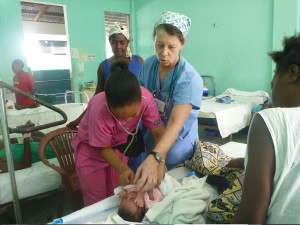 Bobbi Kimsey assists with newborn exam in Haiti
